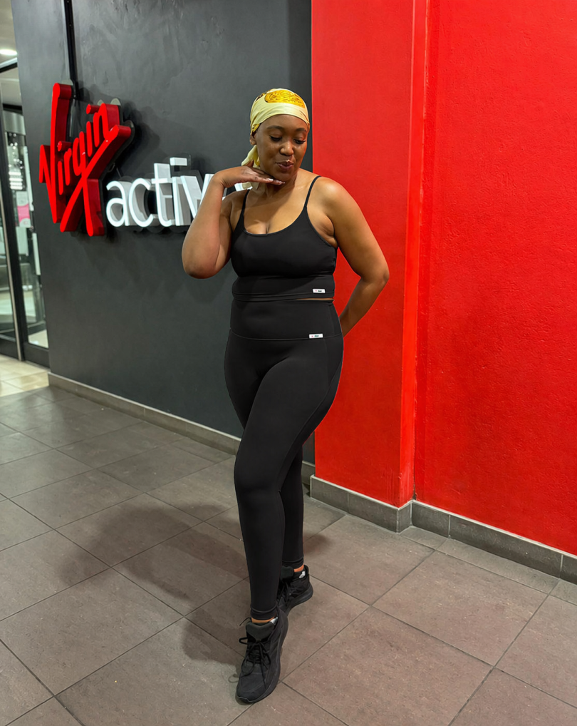 Woman wearing black Sculpt Mint strappy athleisure two-piece gym outfit at fitness studio in South Africa
