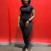 Full length mirror selfie of Mint Athleisure Essence two-piece set in black. Standard in front of Virgin Active gym wall