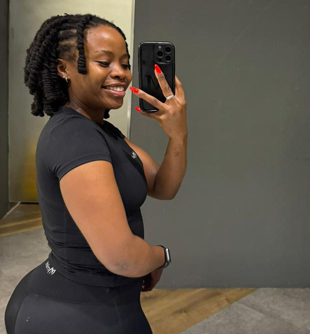 Side view of woman in Mint Essence black high-waisted gym set showing contouring fit.