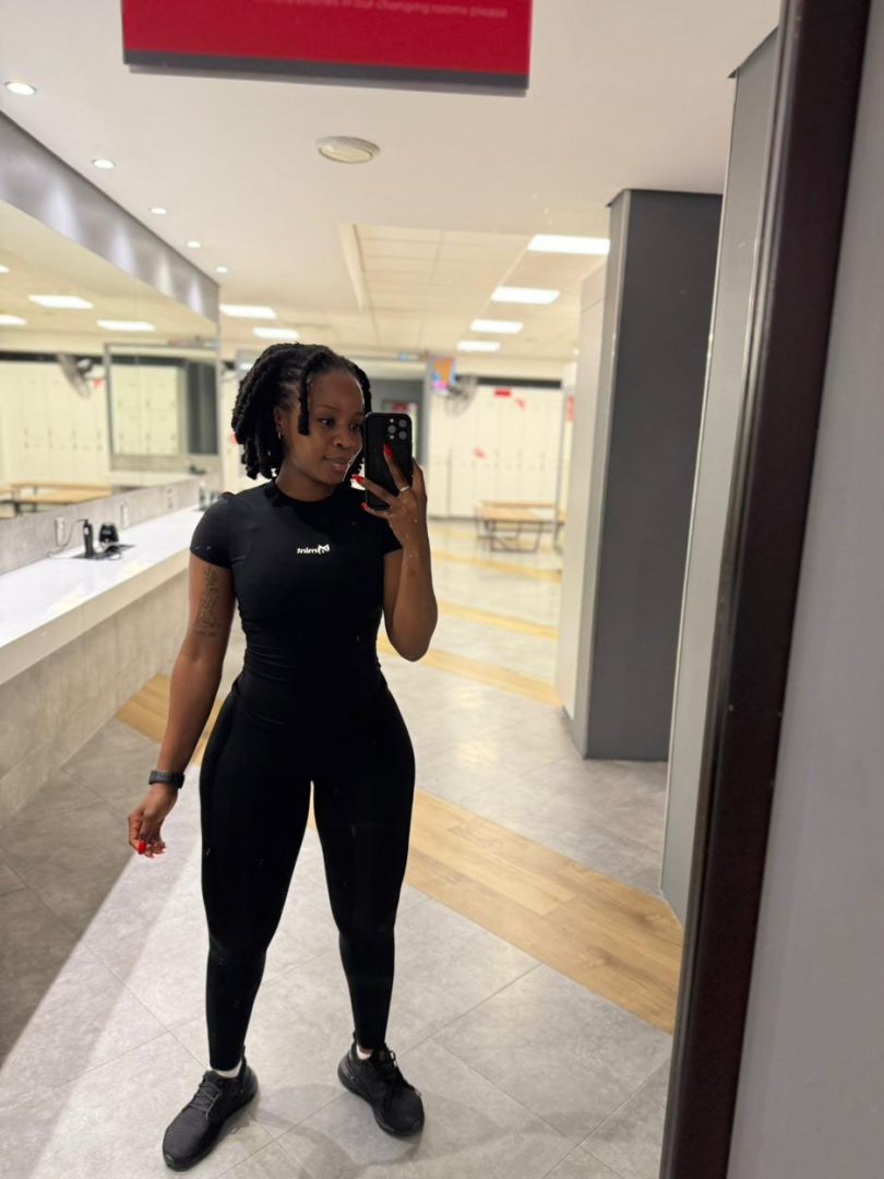 Full length mirror selfie of Mint Athleisure Essence two-piece set in black.
