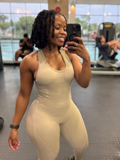 Full-length mirror selfie of the Mint Flow Jumpsuit showcasing the tapered waist and contouring seams