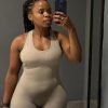 Full-length mirror selfie of the Mint Flow Jumpsuit showcasing the tapered waist and contouring seams with black iPhone