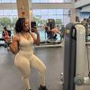 Front view of woman in Stone Beige Mint Flow Suit showing the seamless, body-hugging fit in a gym.