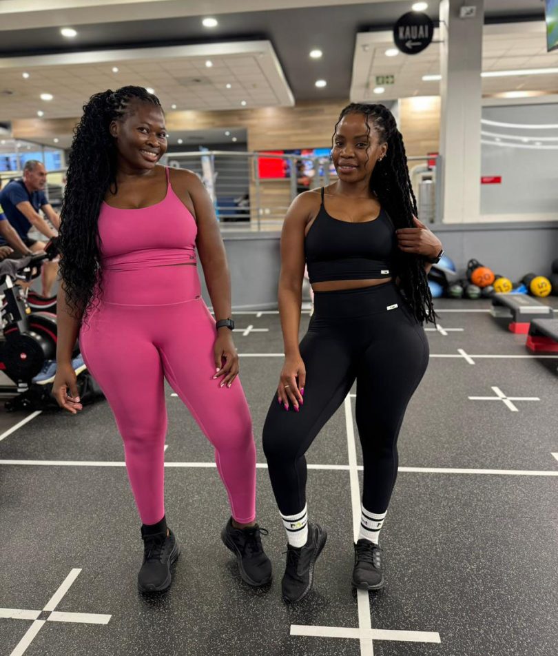 Comparison of the Sculpt Mint Strappy Gym Set in Fuchsia Pink and Classic Black on different body types. Showcasing high-waisted compression leggings and supportive strappy tops in a professional gym setting. Ideal for inclusive fitness fashion in South Africa.