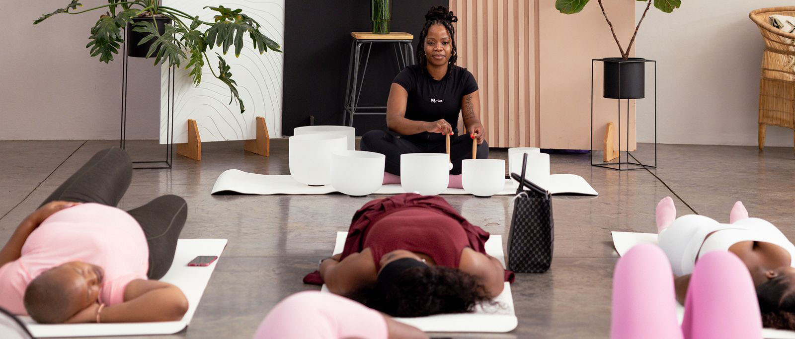 Women մասնակցating in a sound healing session led by Motshidisi Mojapelo at Mint Sanctuary, focusing on relaxation, mindfulness and holistic wellness